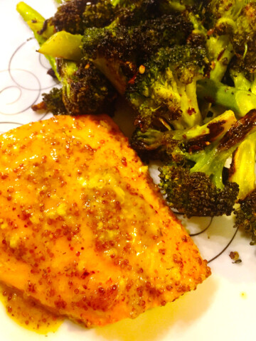 Honey mustard chicken with broccoli on a white plate