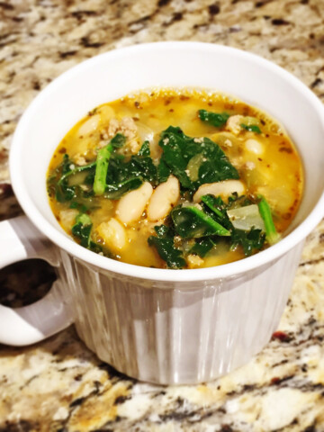 White bean turkey chili in a mug on a counter