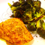 Honey mustard chicken with broccoli on a white plate.