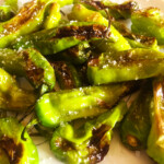 Blistered Shishito Peppers on a white plate
