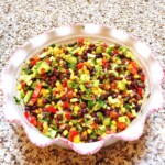 Black bean salad in a ceramic bowl on a marble counter