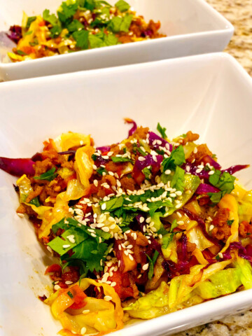 Egg roll in a bowl in white dishes on a counter