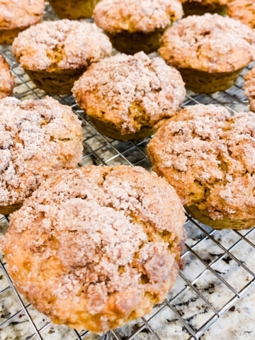 Muffins on a cooling rack on a counter