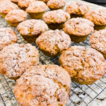 Pumpkin banana muffins on a cooling rack on a countertop