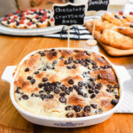 Chocolate croissant bake on a wood table with pastries in the background