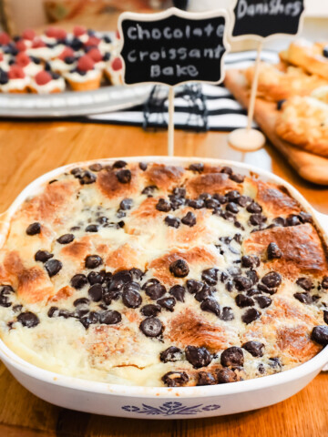 Chocolate croissant bake in a dish on a wood table