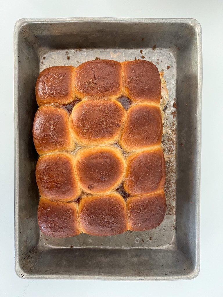 Baked turkey sliders on a pan.